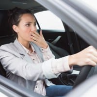 Nervous businesswoman crashing her car during her trip